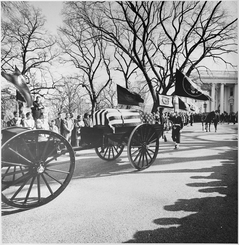 a photo of the casket of President John F. Kennedy leaving the White House
